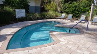 Huge Outdoor Hot Tub surrounded by paver patio