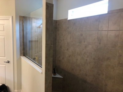  Roman Shower with tan tile and glass half wall