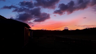 Sunset orange horizon with big purple clouds